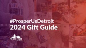 Promotional image for the #ProsperUsDetroit 2024 Gift Guide. The background features a collage of items, such as notebooks, sunglasses, potted plants, books, clothing, and other gift ideas, overlaid with a red gradient. Centered text reads "#ProsperUsDetroit 2024 Gift Guide" with the ProsperUs Detroit logo at the bottom.