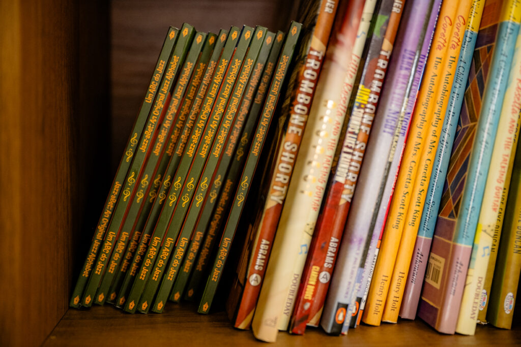Shelf of Black children’s books at Vesey Lane Goods including Jazz-a-bet by Robin Wilson, promoting literacy and Black cultural history.