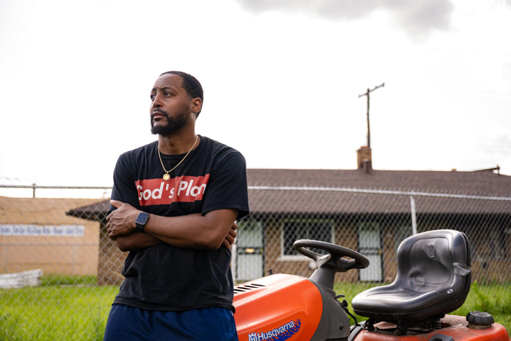 Kenneth Nixon in front of a House.