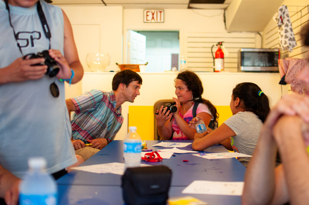 Pastor John engages in a photography workshop at Grace in Action’s former space in July 2013, now home to El ArteSano.